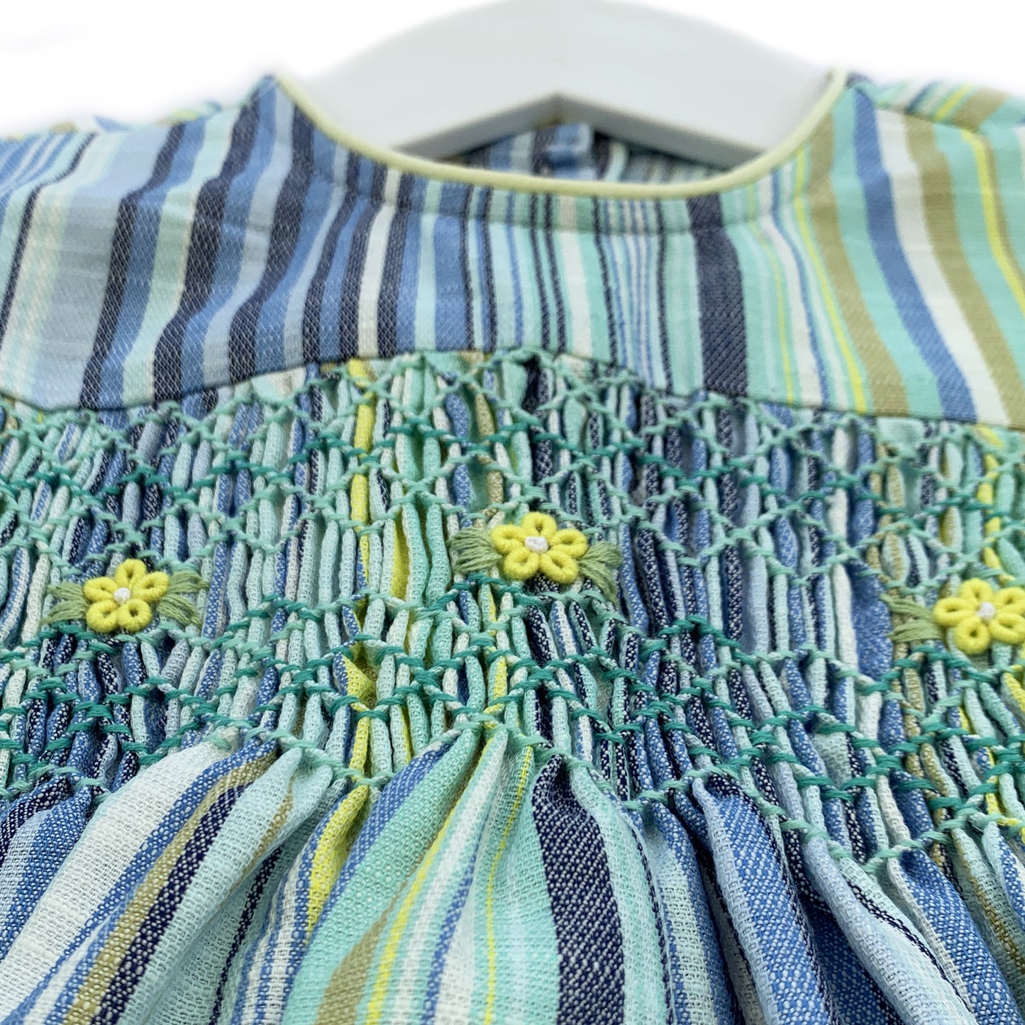 Tasteful long sleeves yellow and blue striped smocked dress.