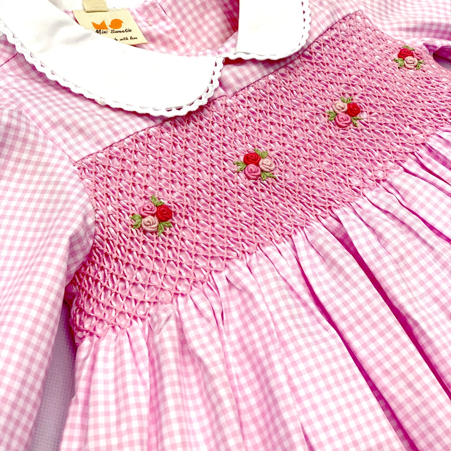 Stunning pink dress hand smocked with tricolor roses.