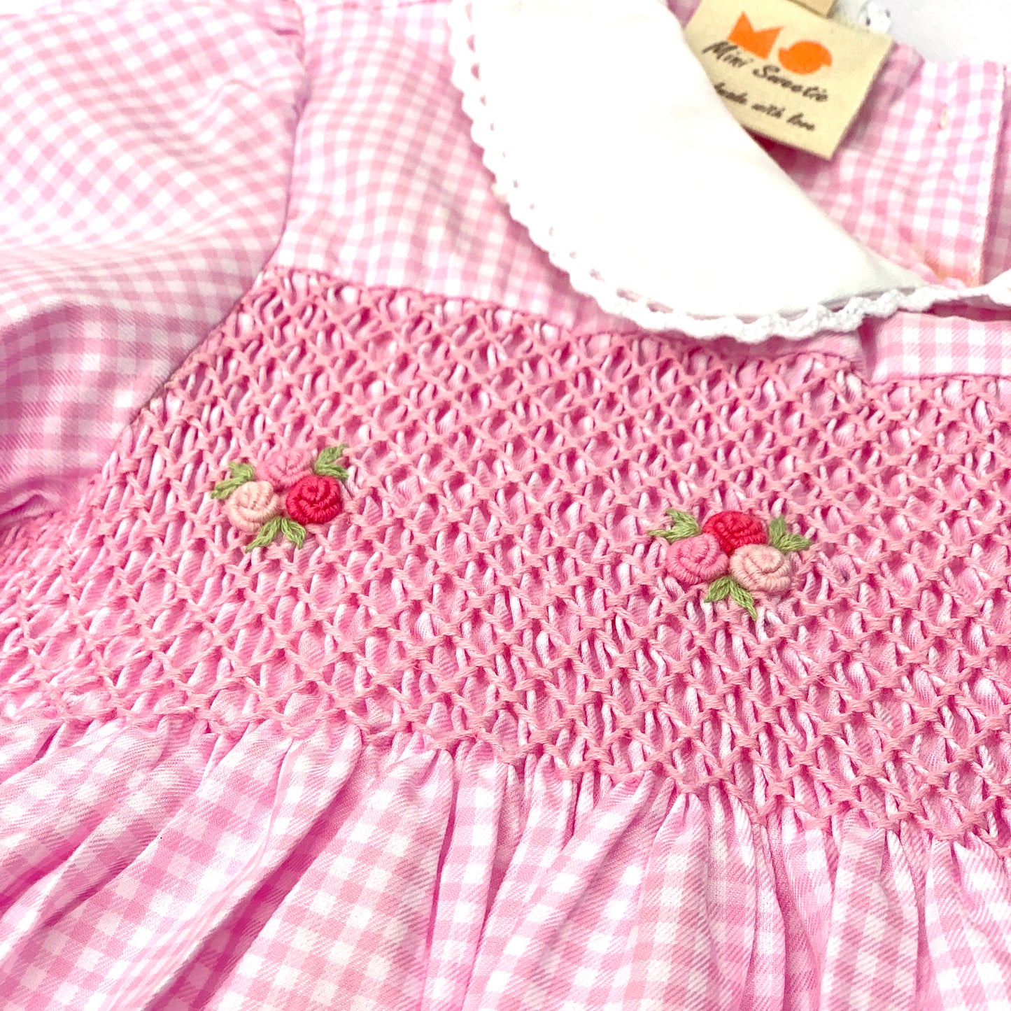Stunning pink dress hand smocked with tricolor roses.
