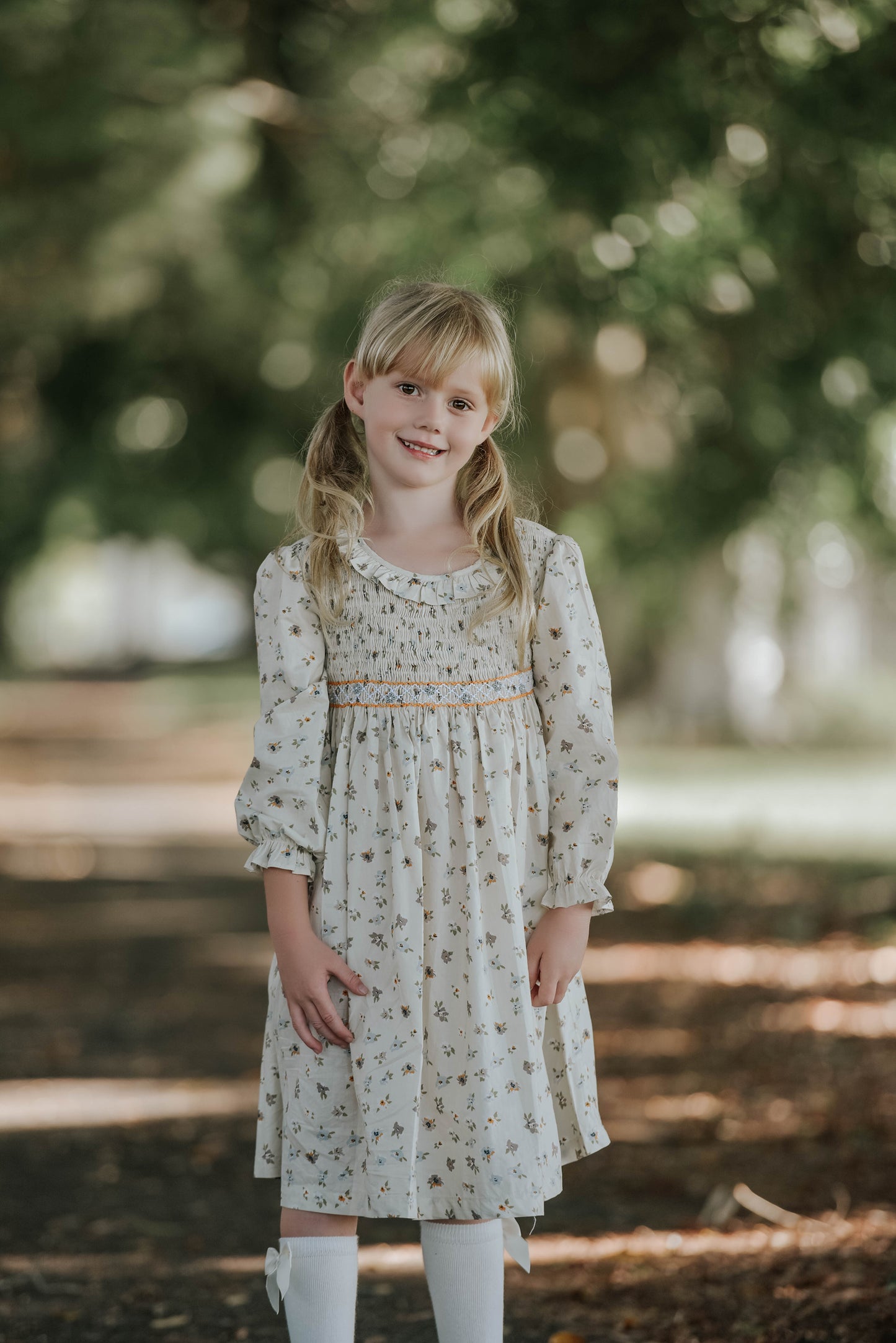 Cream long sleeves hand smocked dress.