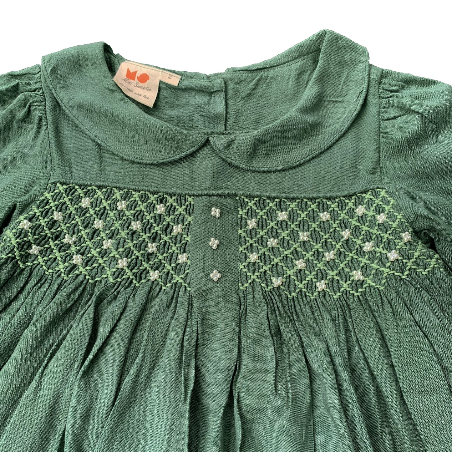 Green long sleeves hand smocked with embroidered pearls