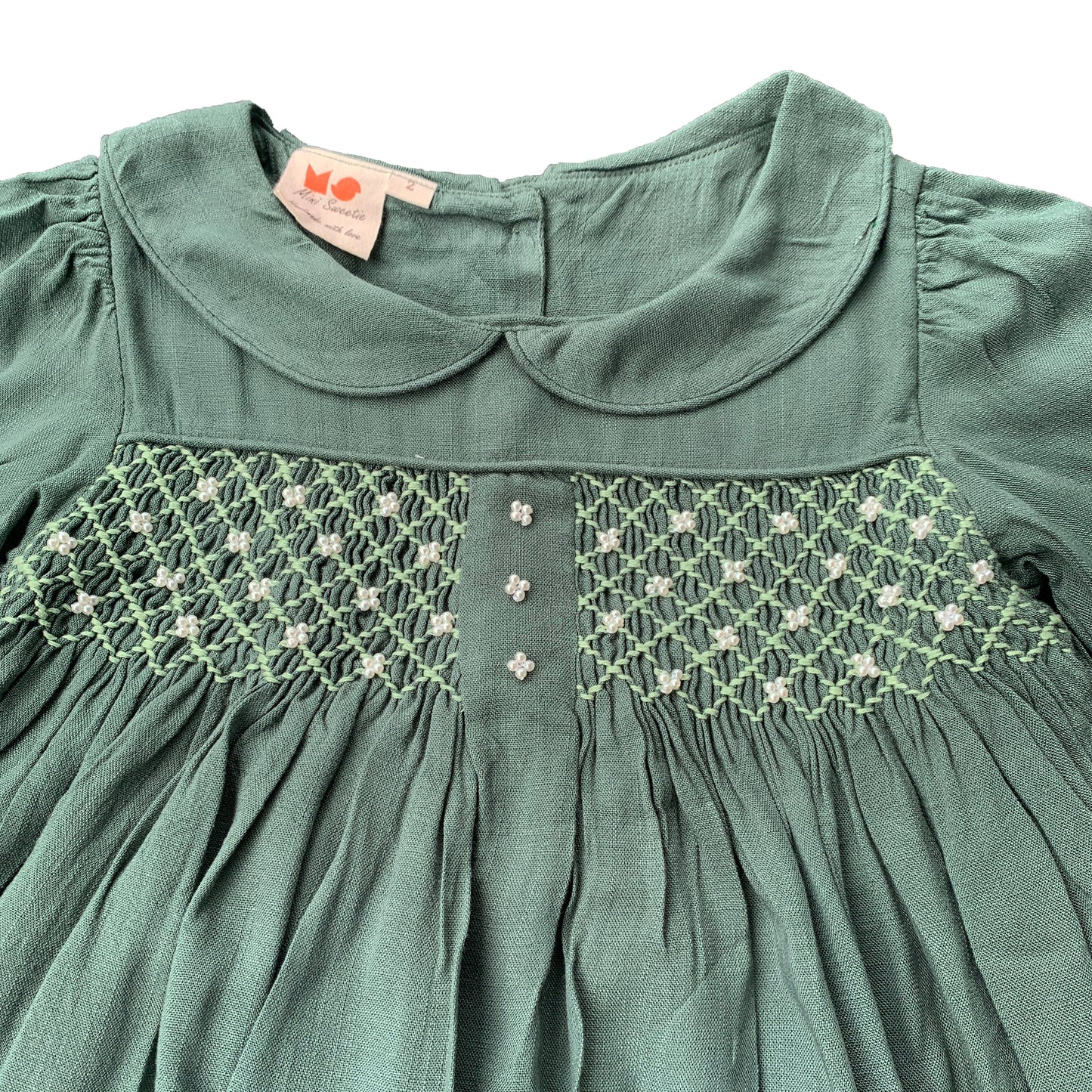 Green long sleeves hand smocked with embroidered pearls