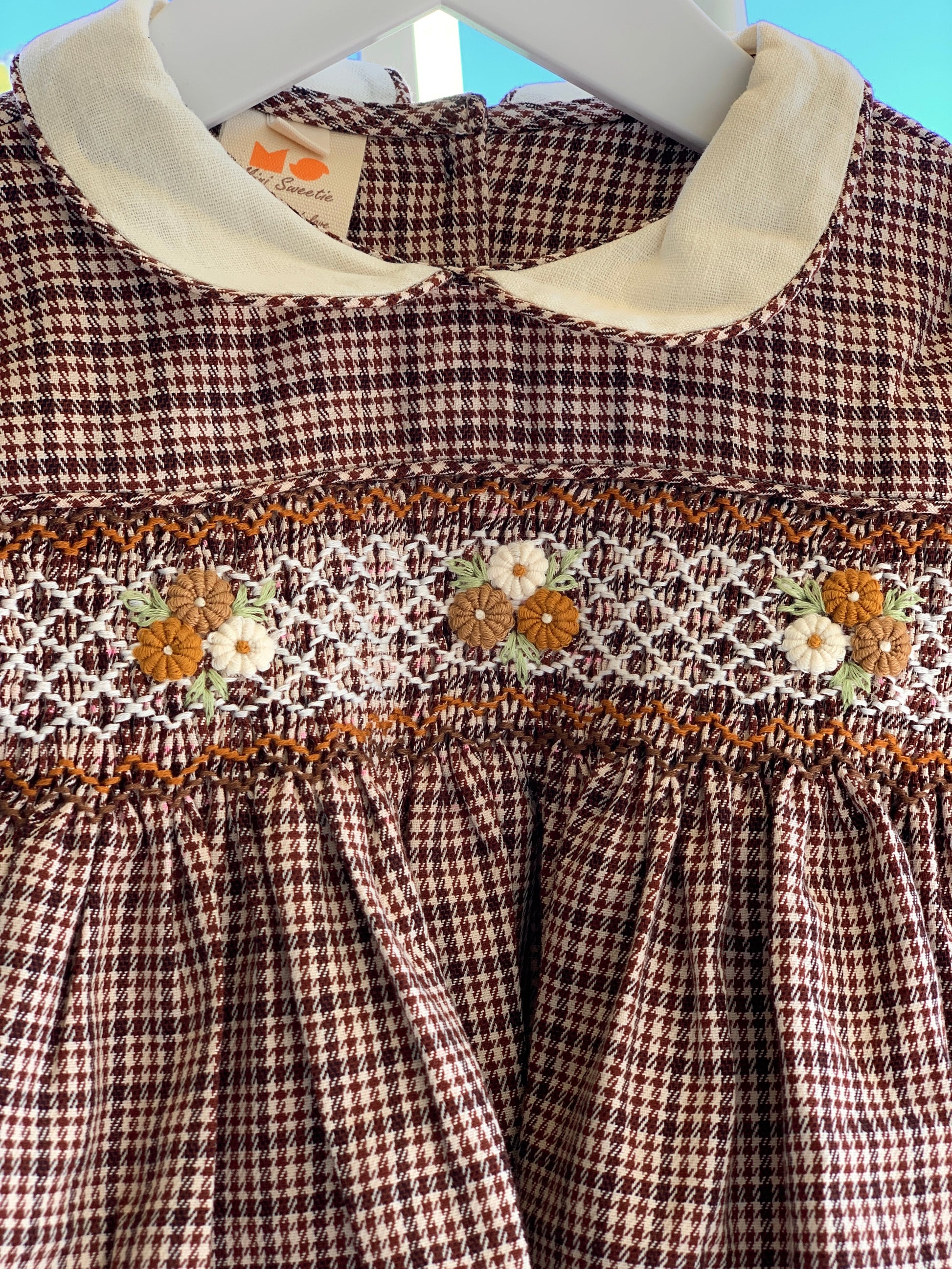 Classic brown checkered smocked dress.
